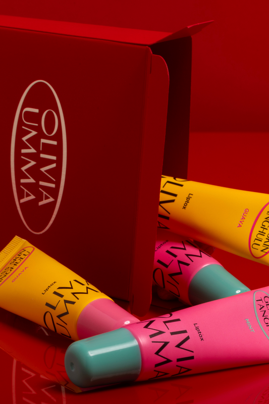 Colorful lip balm tubes with 'Olivia Umma' branding on a red background