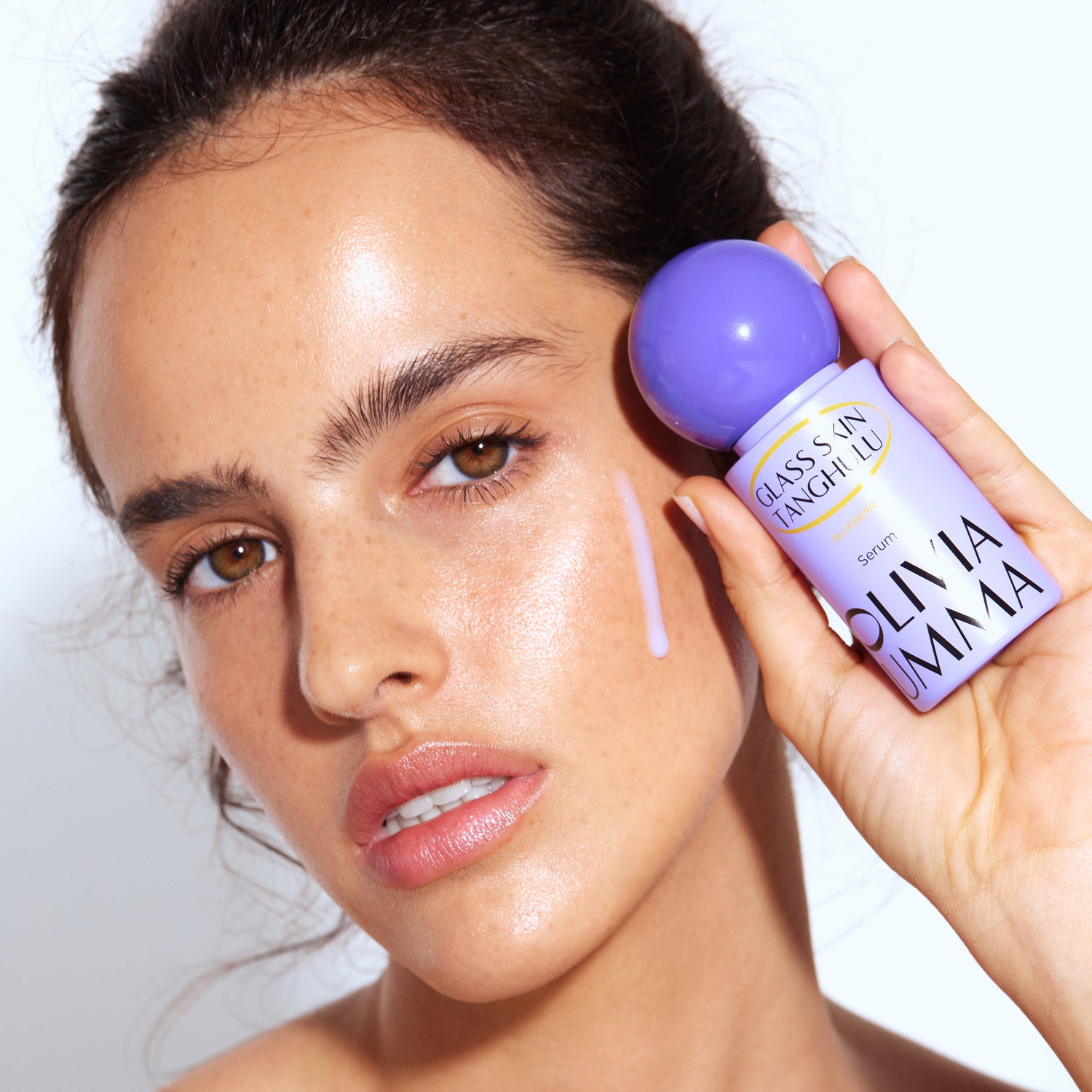 women holding blueberry serum