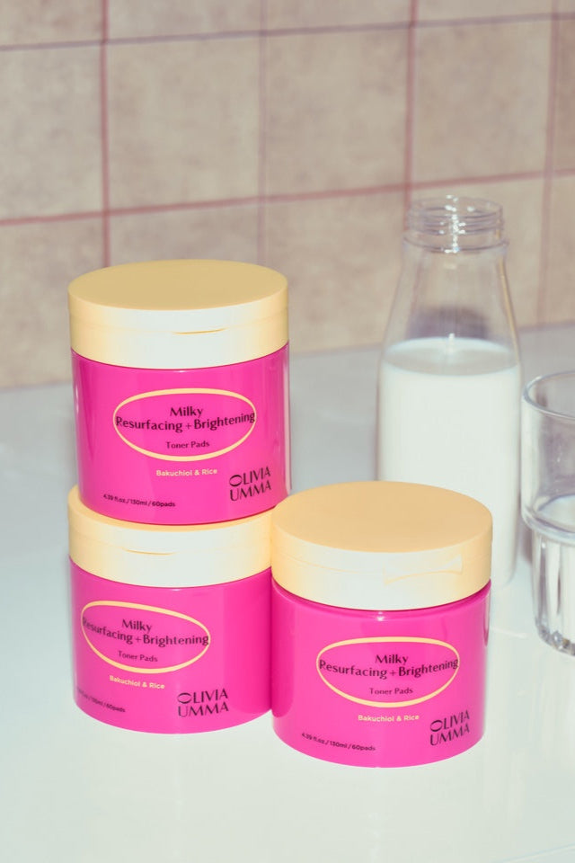 Three Milky Resurfacing + Brightening Toner Pads white surface against a tiled wall background.