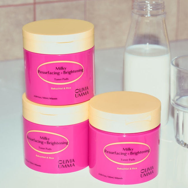 Three Milky Resurfacing + Brightening Toner Pads white surface against a tiled wall background.