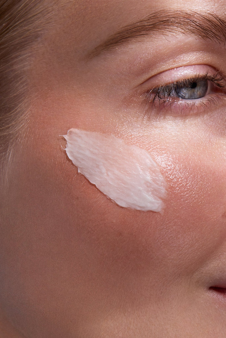 Close-up of a person's face ULTIMATE BARRIER RESTORE CREAM applied to the cheek.
