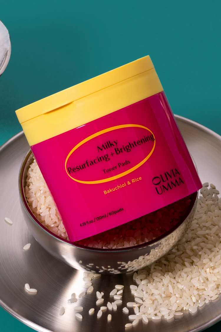 Milky Resurfacing + Brightening Toner Pads on a metal tray with rice