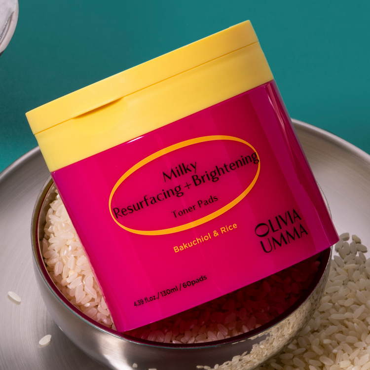 Milky Resurfacing + Brightening Toner Pads on a metal tray with rice