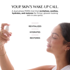 A woman spraying a mist from a small white bottle onto her face, with marketing text above reading 'YOUR SKIN'S WAKE-UP CALL.' and bullet points about revitalizing, hydrating, and restoring.