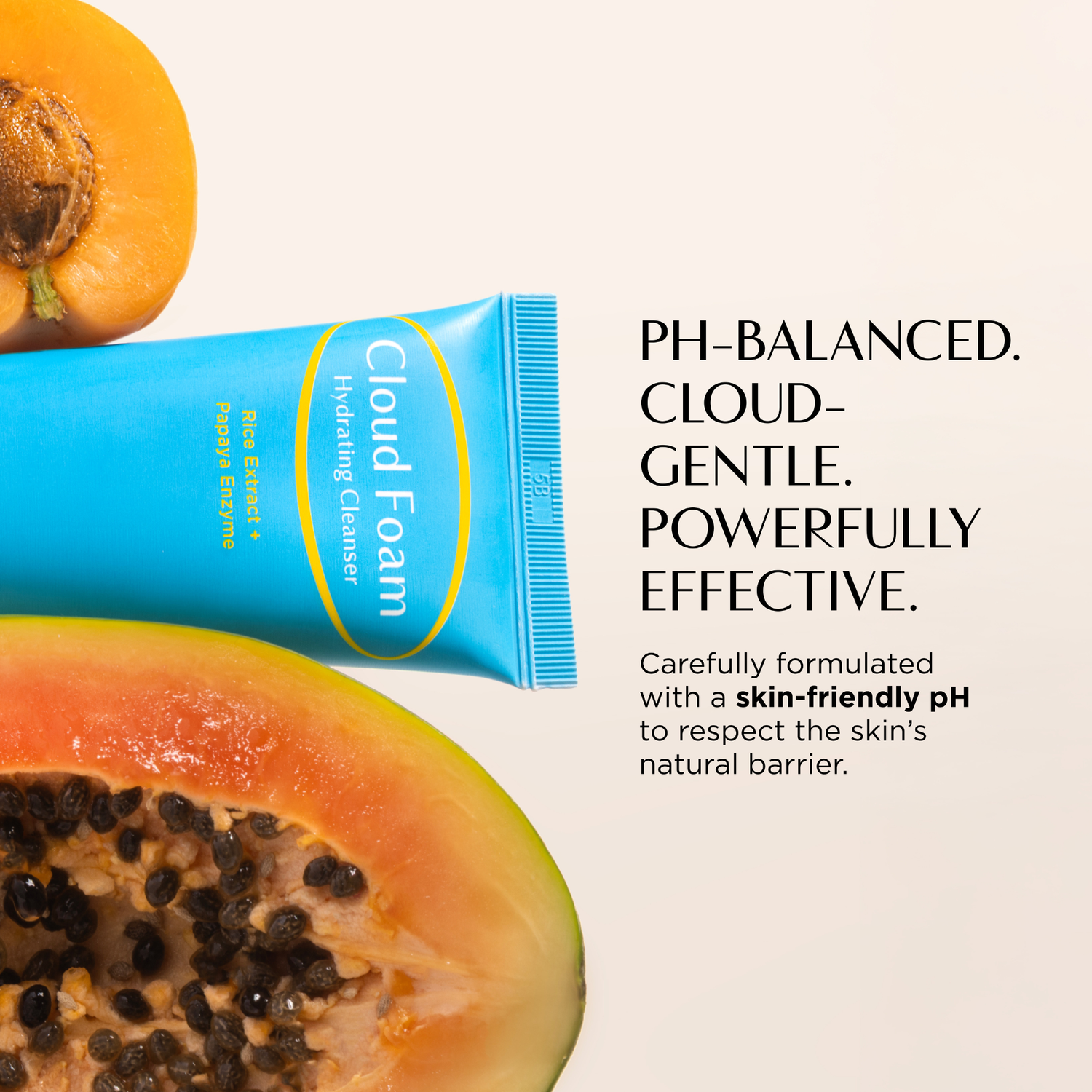 Cloud Foam tube with a halved papaya on a light background