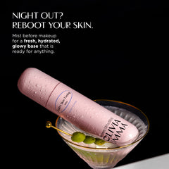 Olivaomma 99% Humidifying Mist in a light pink cylindrical bottle with water droplets, presented diagonally in a martini glass with olives on a black background with NIGHT OUT? REBOOT YOUR SKIN