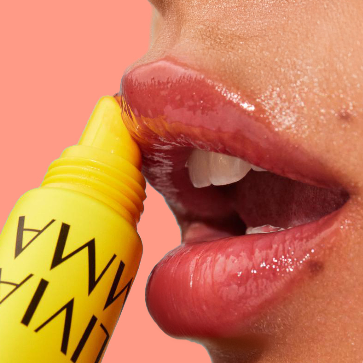 Close-up of a person applying yellow lip gloss with a pink background