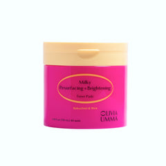 Pink container of Olivia Umma toner pads with beige lid on a white background