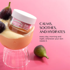 Jar of cream with figs on a pink background, featuring text about skin care benefits.