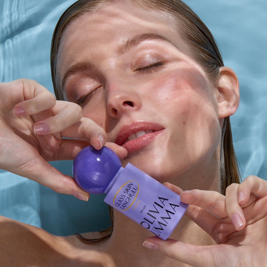 Person holding 'Olivia Umma' product by a pool.