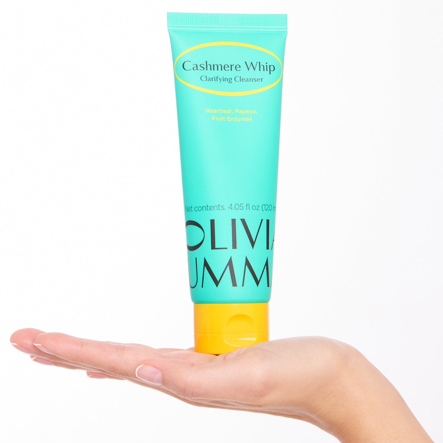 Tube of Oliviamm Cashmere Whip on a hand against a white background