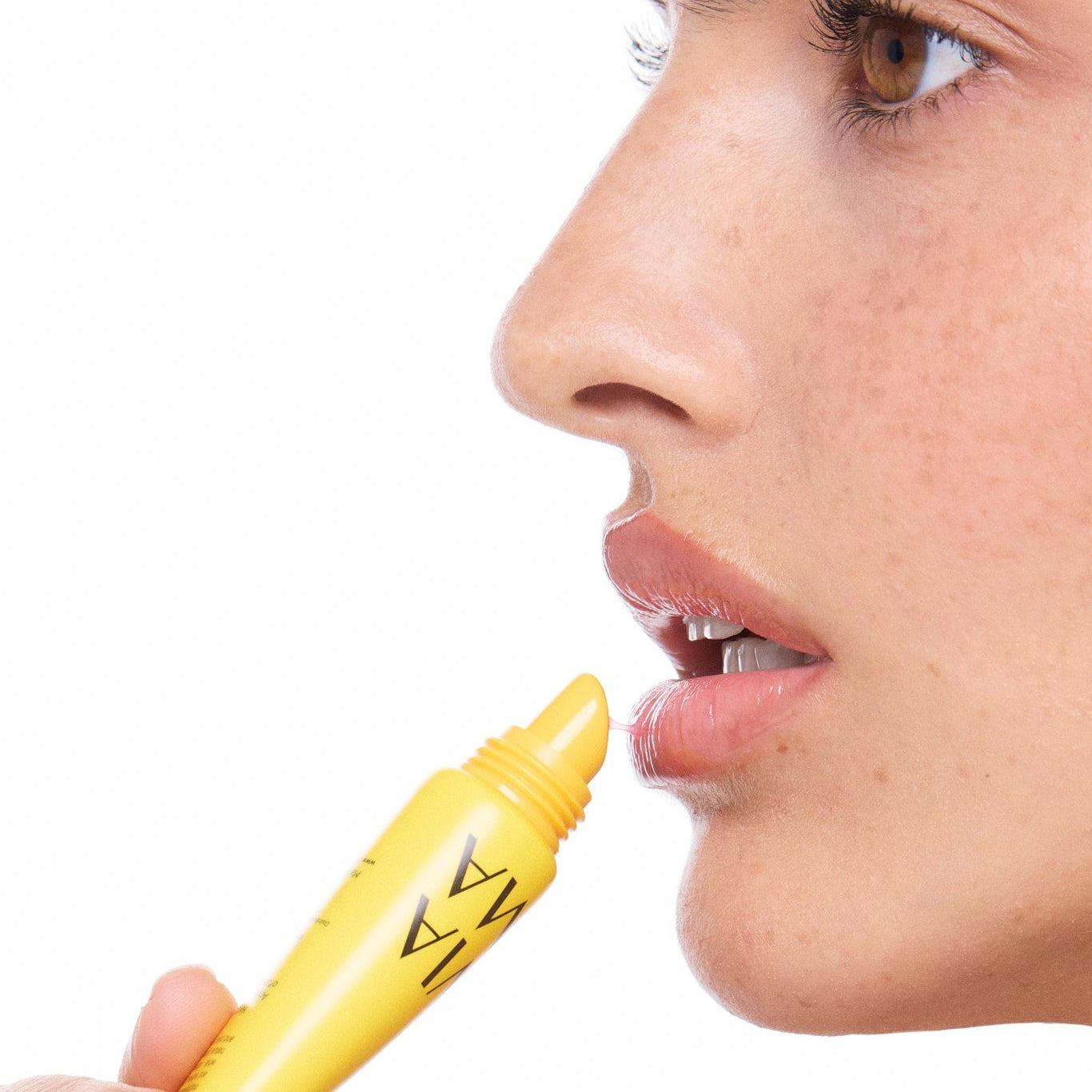 Person holding a lip tox guava product close to their lips on a white background