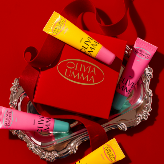 Olivia Umma lip balm tubes on a red background with gift box