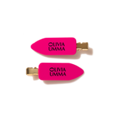 Two pink hair clips with 'Olivia Umma' branding on a white background